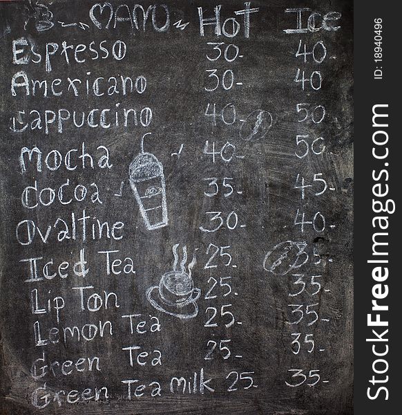 Menu in front of coffee, chalk on black board: coffee, espresso, cappuccino