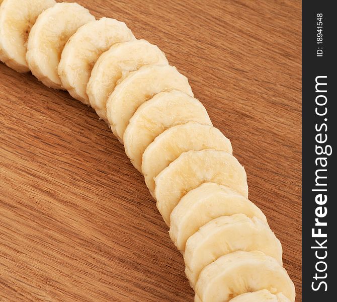 Sliced bananas on a wooden background