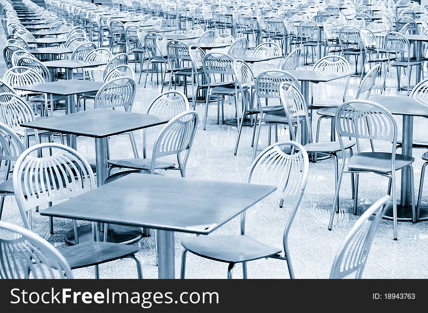 Tables and chairs in fast food cafe