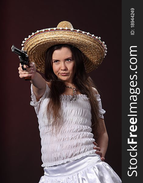 Woman in a mexican costume hold revolver. Woman in a mexican costume hold revolver