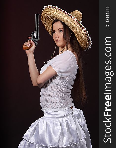 Woman in mexican costume hold revolver. Woman in mexican costume hold revolver