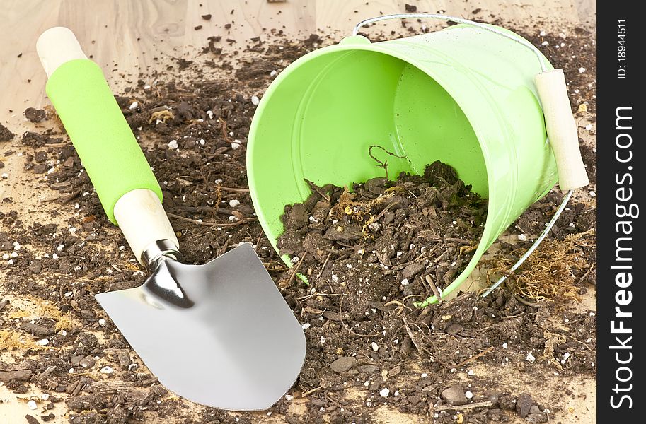 A spade ,bucket and soil representing gardening. A spade ,bucket and soil representing gardening