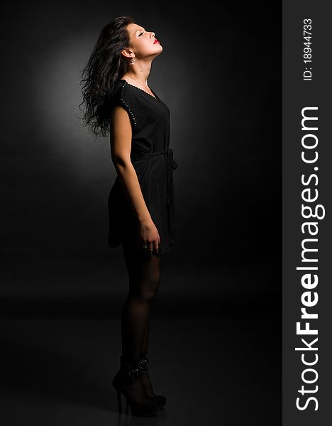 Art fashion photo of young woman on black