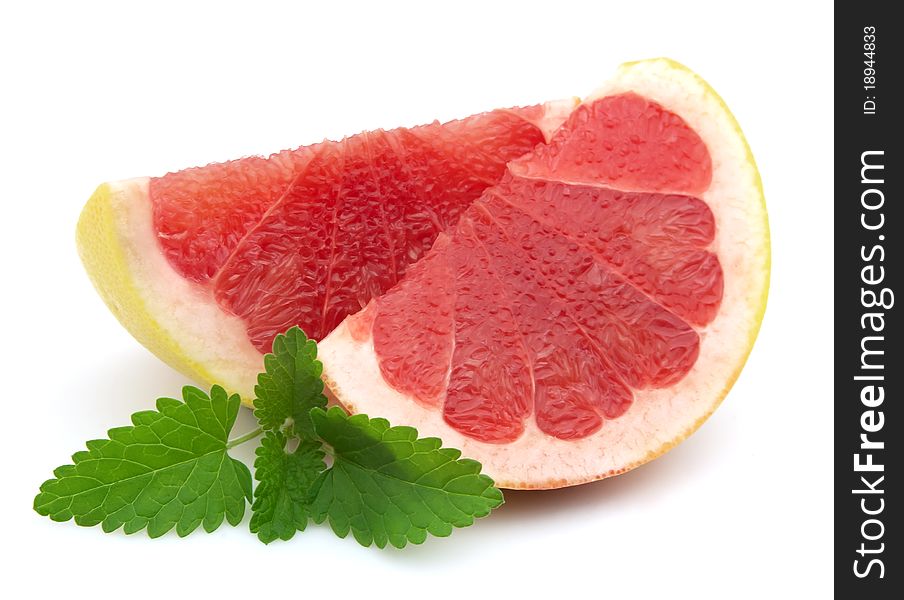 Ripe grapefruit with mint closeup