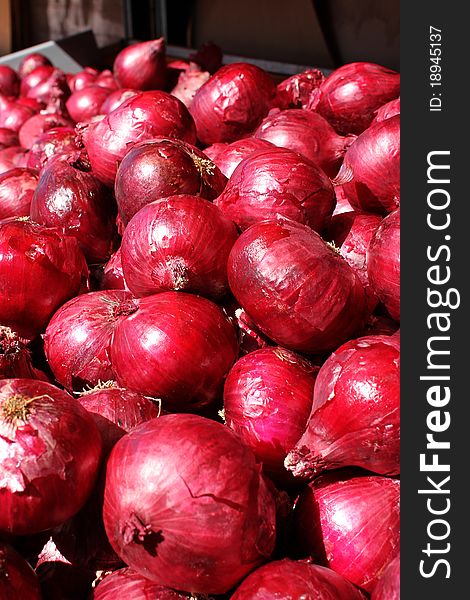 Organic red onions in the marketplace