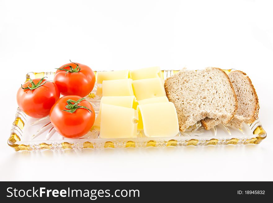 Picture of tomatoes, cheese, and some bread on a glass plate. Picture of tomatoes, cheese, and some bread on a glass plate.