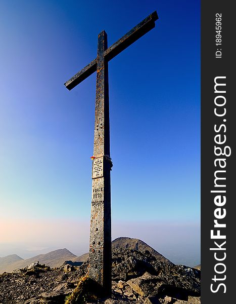 An iron cross on the top of the highest mountain in Ireland called Carrauntoohil. An iron cross on the top of the highest mountain in Ireland called Carrauntoohil.
