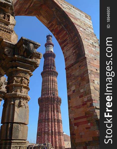 The qutub minar seen through an arch