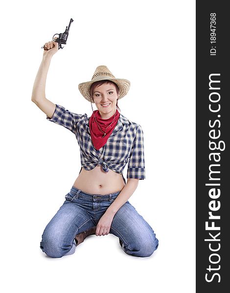 Rodeo cowgirl in torn jeans, boots and cowboyhat. Portrait of Cowboy Holding Gun Up..