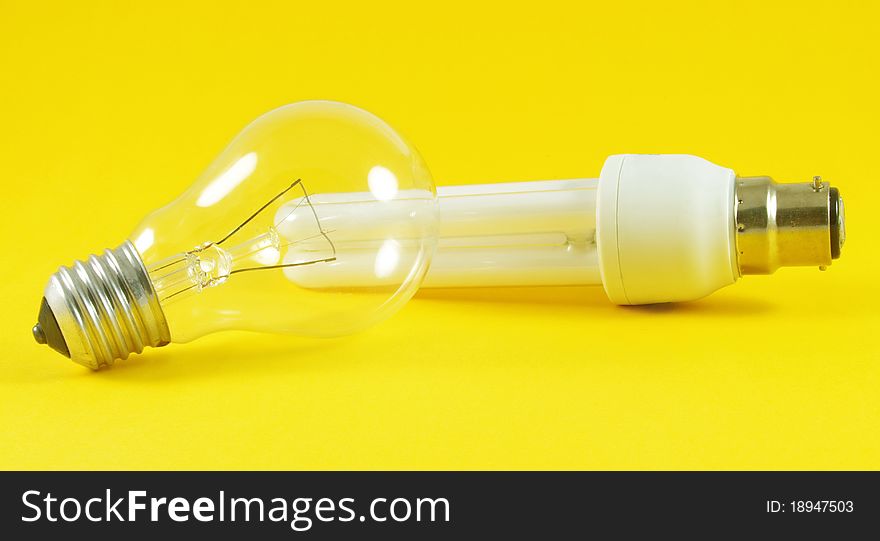 Economic and regular light bulbs over yellow background. Economic and regular light bulbs over yellow background