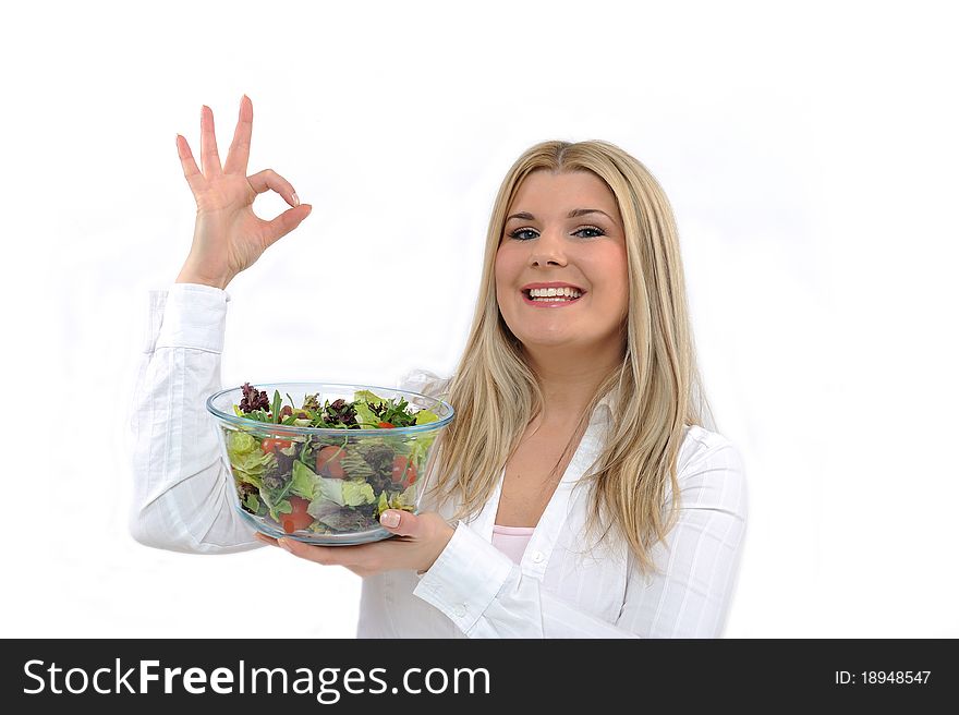 Pretty woman eating green vegetable salad. isolated on white