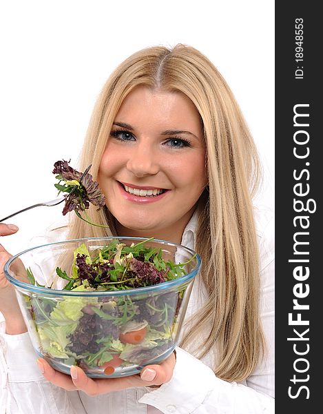 Pretty woman eating green vegetable salad. isolated on white