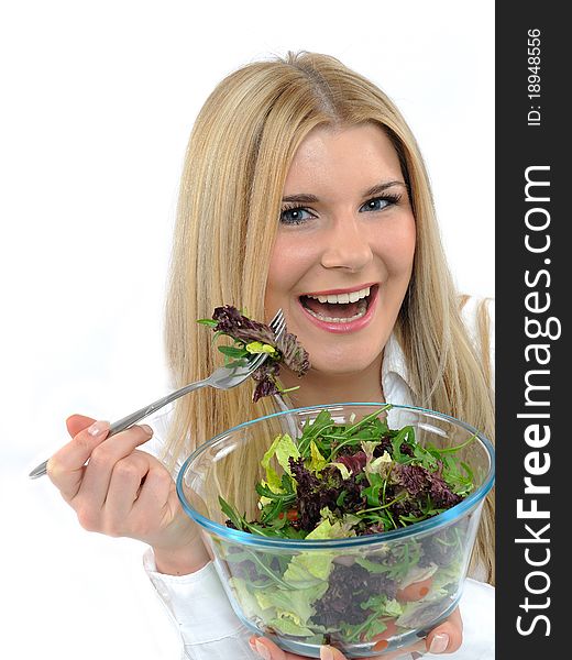 Pretty woman eating green vegetable salad. isolated on white