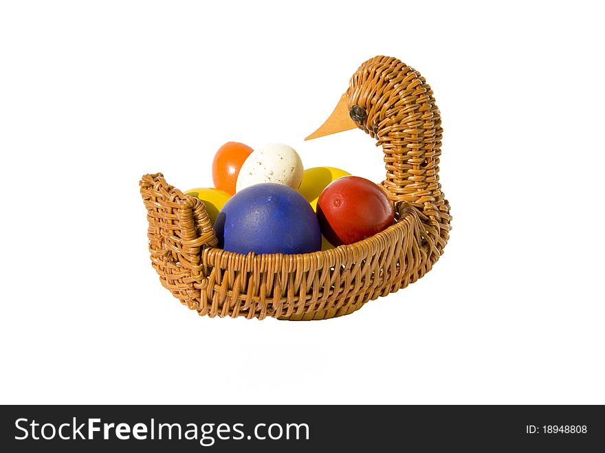 Isolated color Easter eggs in basket on white background