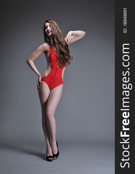 Woman posing in red swimsuit