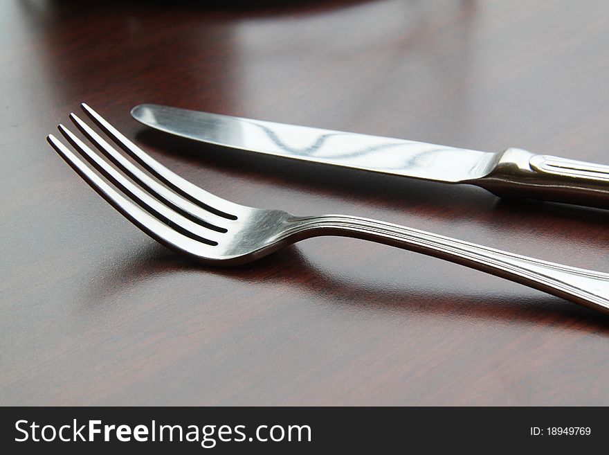 Fork and spoon isolated on dining table