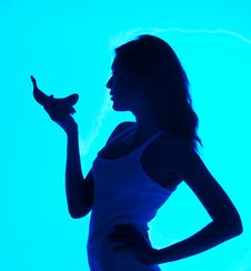 Silhouette Of The Woman With A Banana In A Hand Royalty Free Stock Photo
