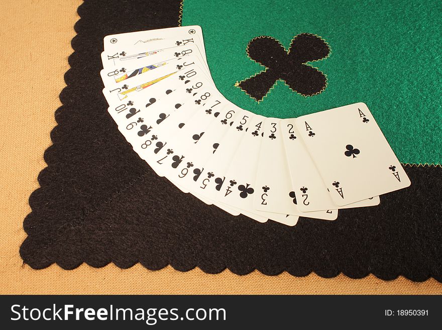 Game table made â€‹â€‹of wood, fabric tablecloth, flower sign , wall-scale poker.