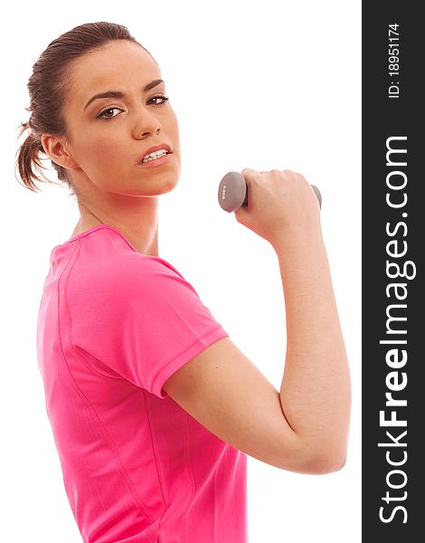 Young girl in a pink top performing an arm curl with a weight. Young girl in a pink top performing an arm curl with a weight