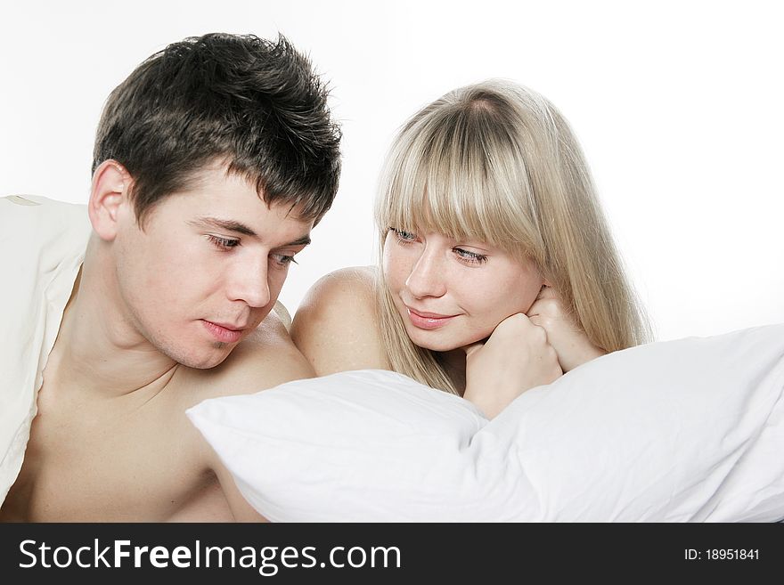 Young couple in bed over white