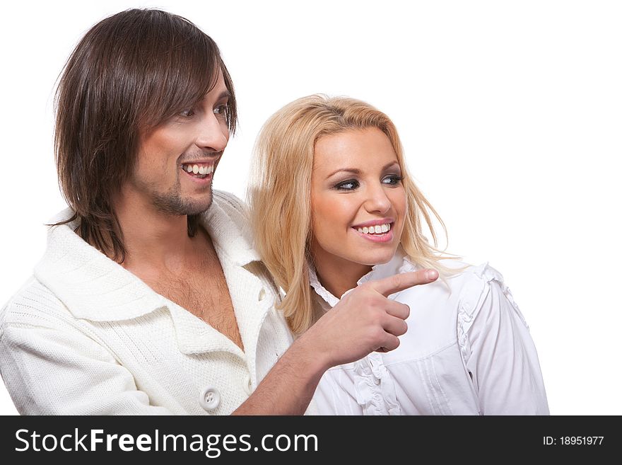 Young Happy Smiling Couple Pointing At Something