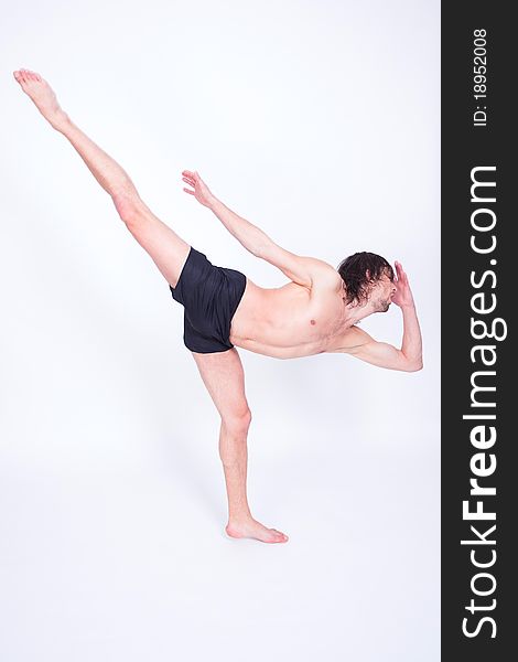 Young attractive man dancing passionate contemporary in studio