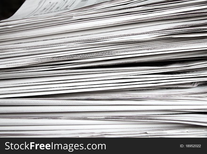 Stack of white newspapers, closeup.