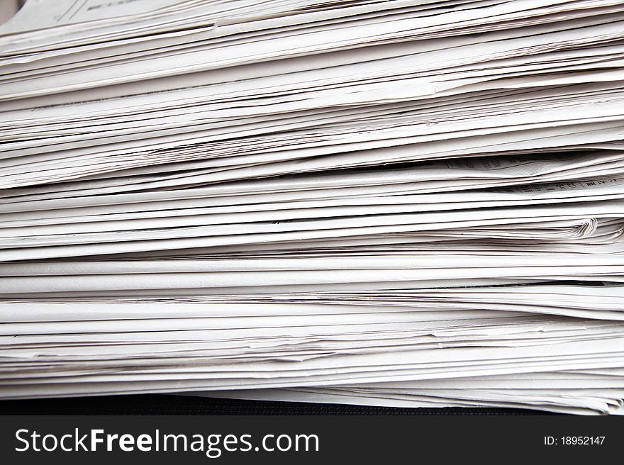 Stack of white newspapers, closeup.