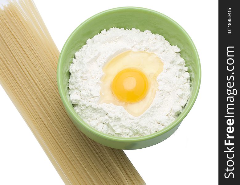 Egg picture in a flour and fedelini on a white background. Egg picture in a flour and fedelini on a white background