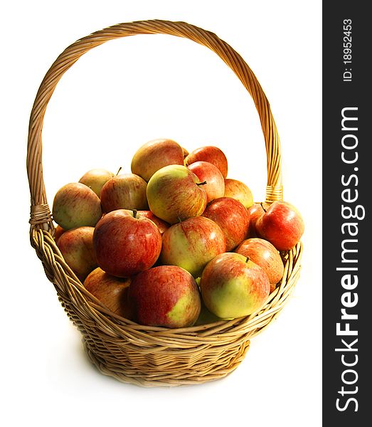 Red ripe apples in a basket on a white background