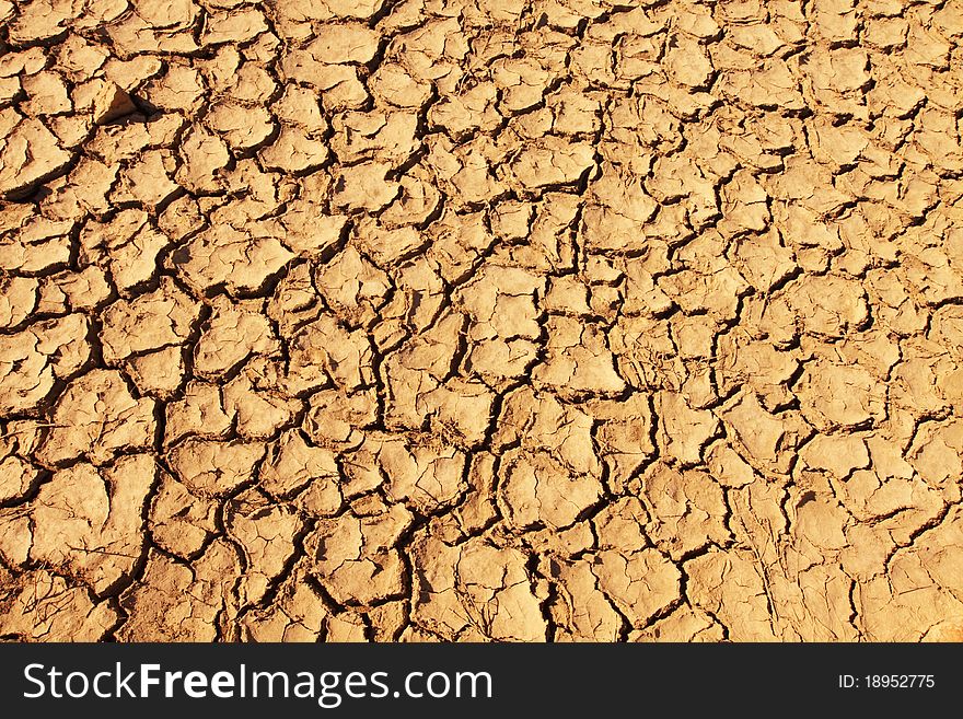 Background of cracked soil on desert