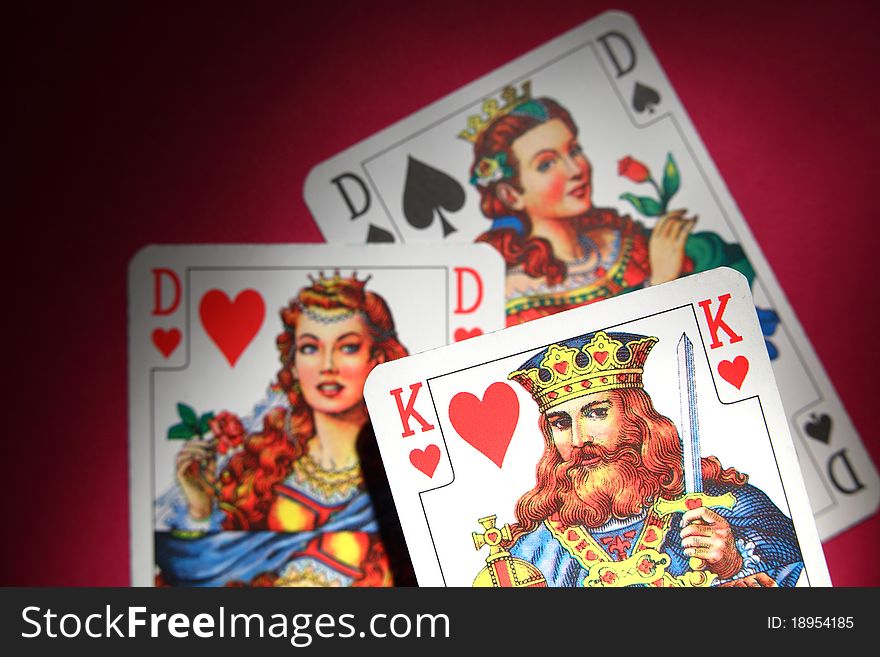 Three playing cards love triangle on red background. Three playing cards love triangle on red background