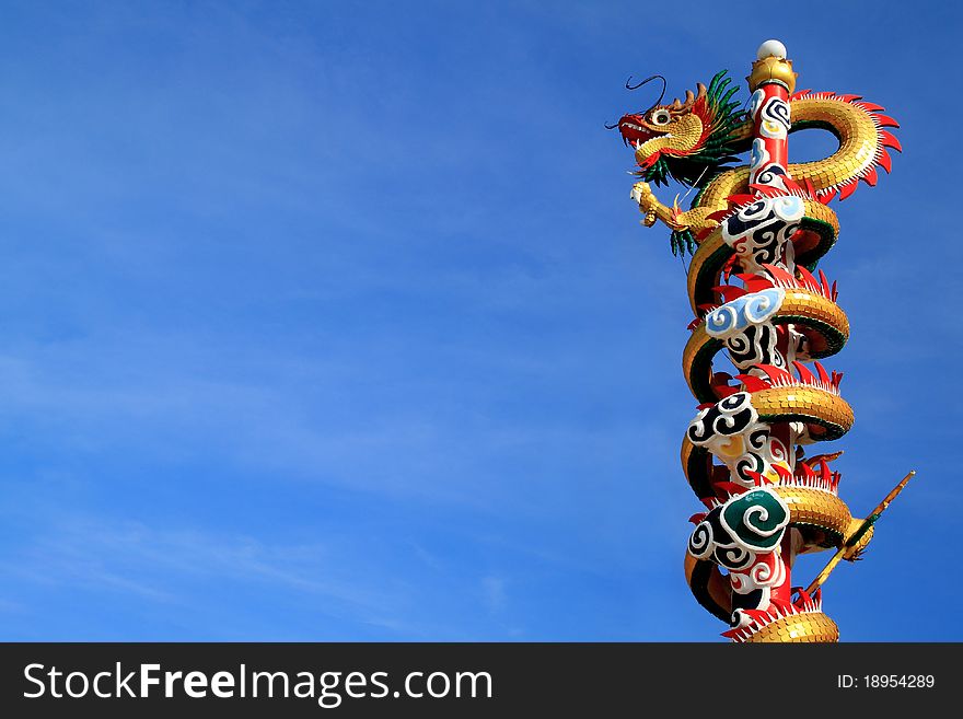 Dragon climbing pole and blue sky