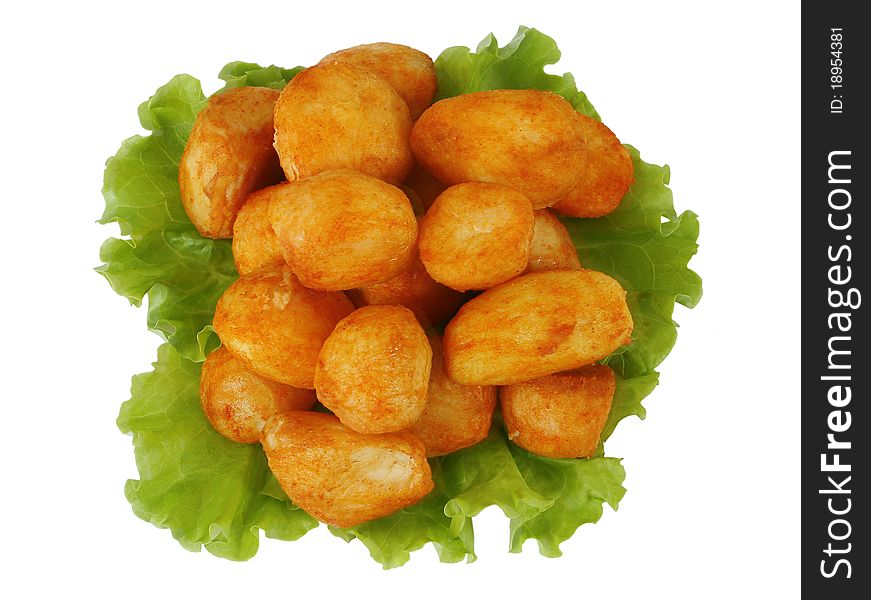 Hot roasted potatoes on salad