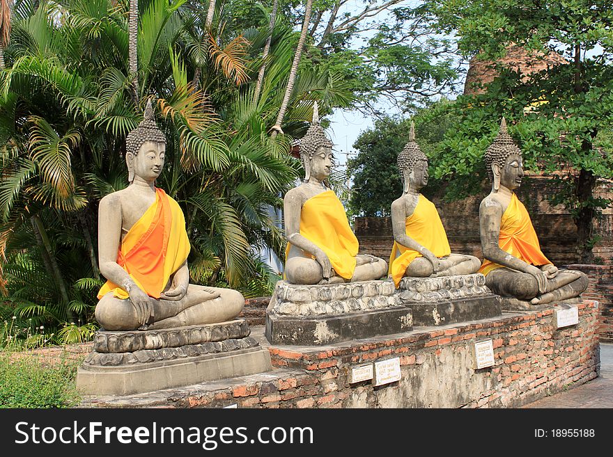 Four Buddha images in the tropical garden in Ayutthaya, Thailand