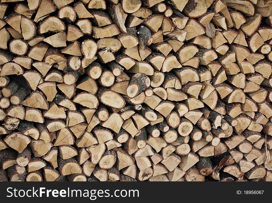 Folding split logs for traditional way of warming. Folding split logs for traditional way of warming