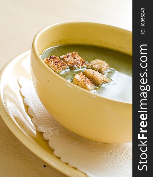 A bowl of homemade spinach soup with crouton and parsley Selective focus