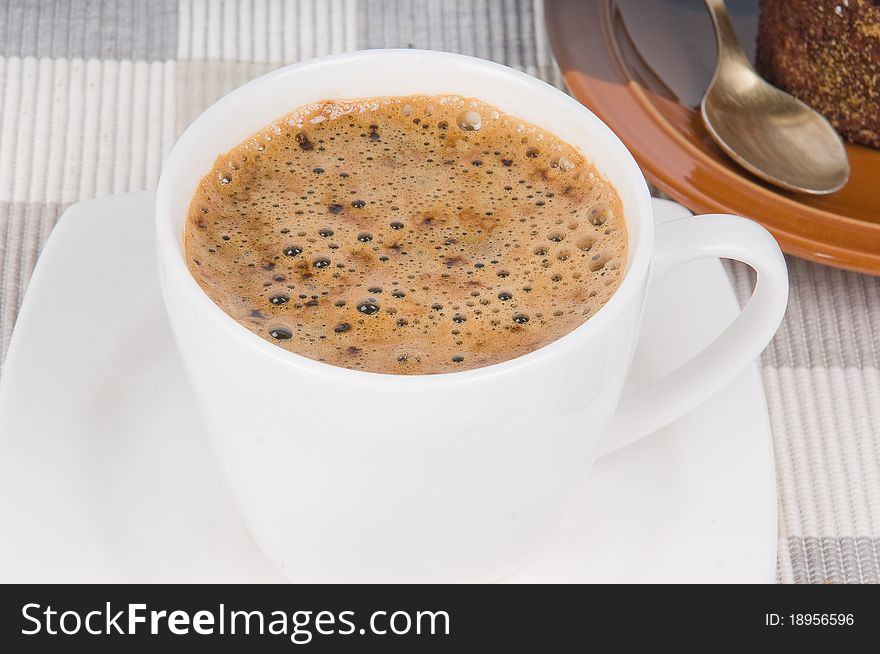 Coffee with cake on textile mat