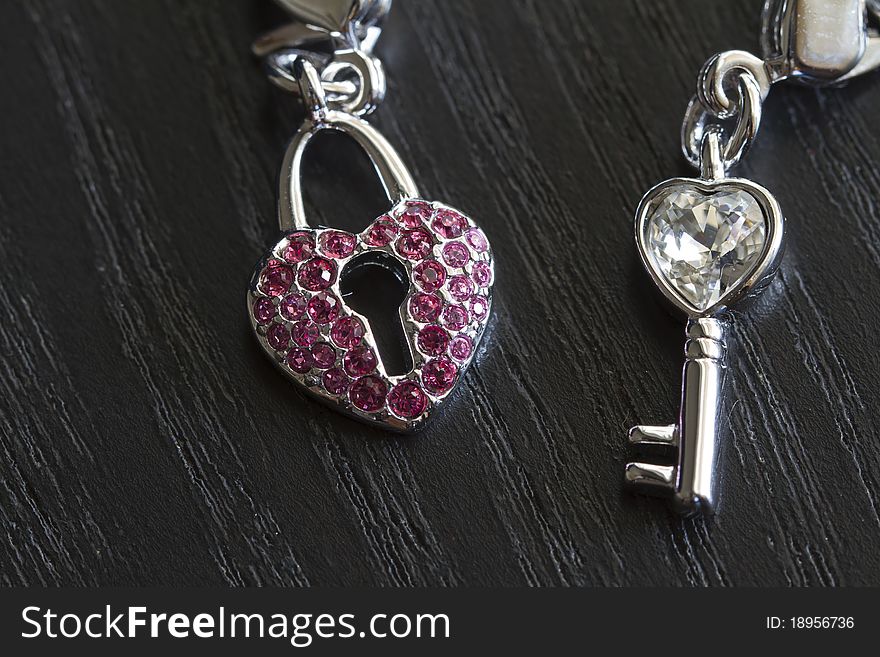 Closeup photo of a heart and key jewerly. Closeup photo of a heart and key jewerly