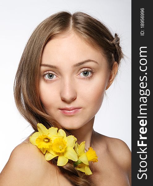 Portrait of the beauty young blond girl with flowers in her hair