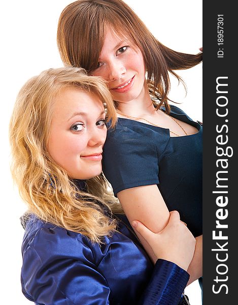 Two young girl friends smiling - isolated over white background.