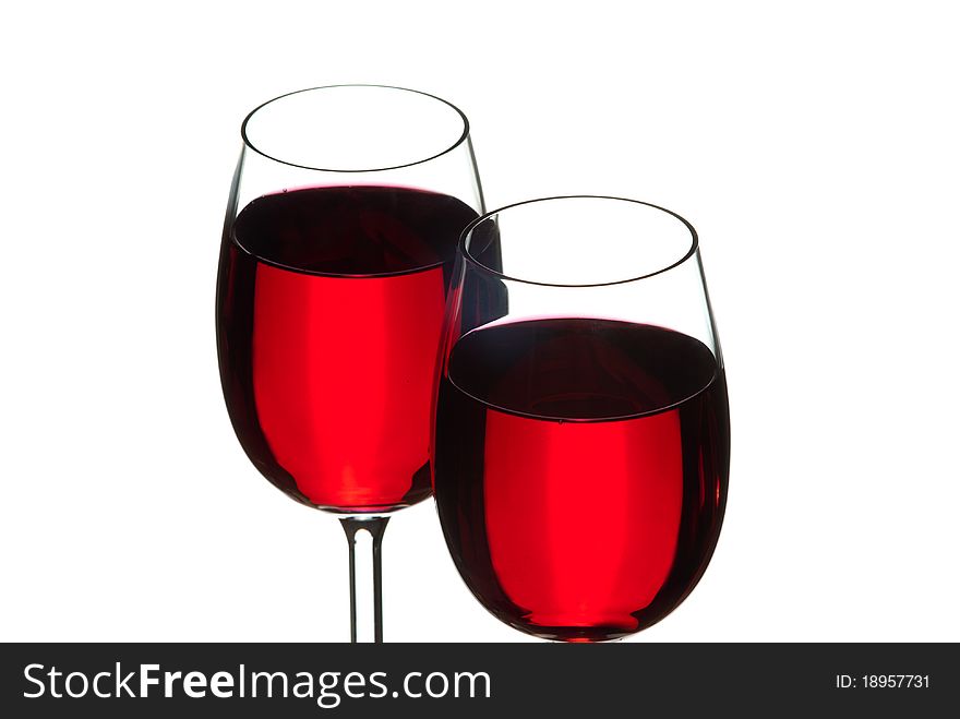 Wine glasses filled with wine. White background. Studio shot.