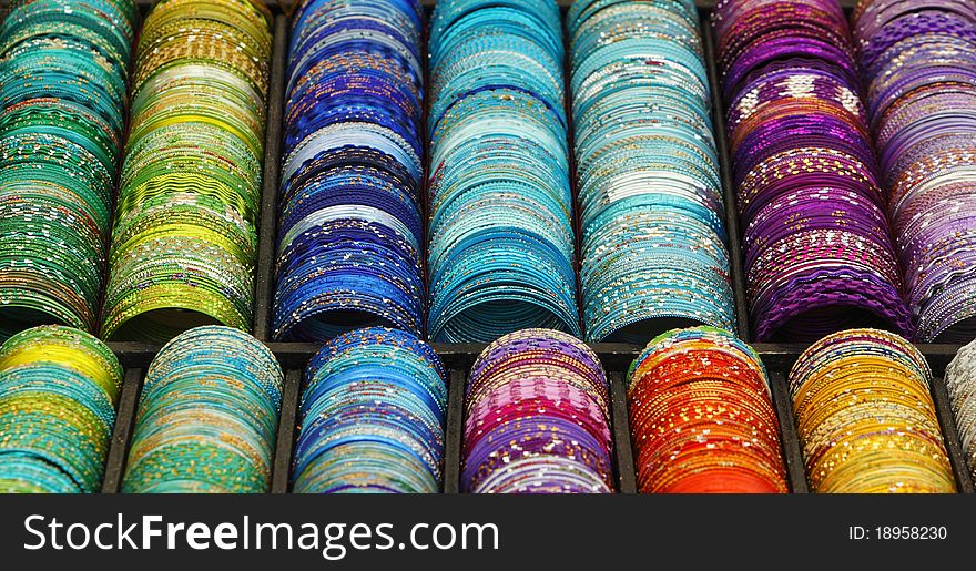Detail of a stand with various colorful bracelets.