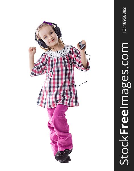 The little girl listens to music and dances. The little girl listens to music and dances