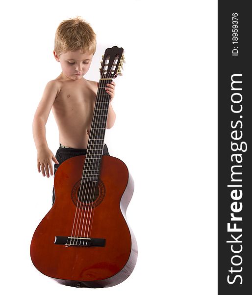 Boy playing a big guitar isolated on a white background. Boy playing a big guitar isolated on a white background