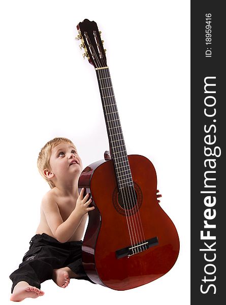 Boy playing a big guitar isolated on a white background. Boy playing a big guitar isolated on a white background