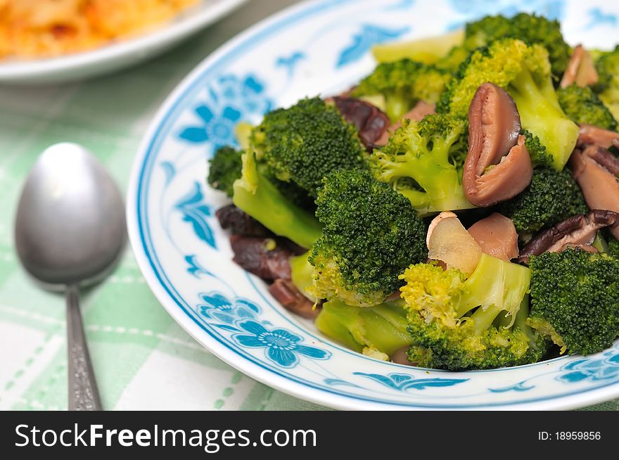 Asian style sit fried healthy fresh broccoli with black mushrooms.