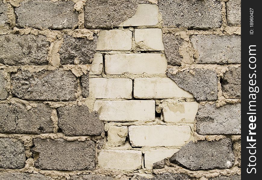 Through a hole in a wall it is visible bricks. Through a hole in a wall it is visible bricks