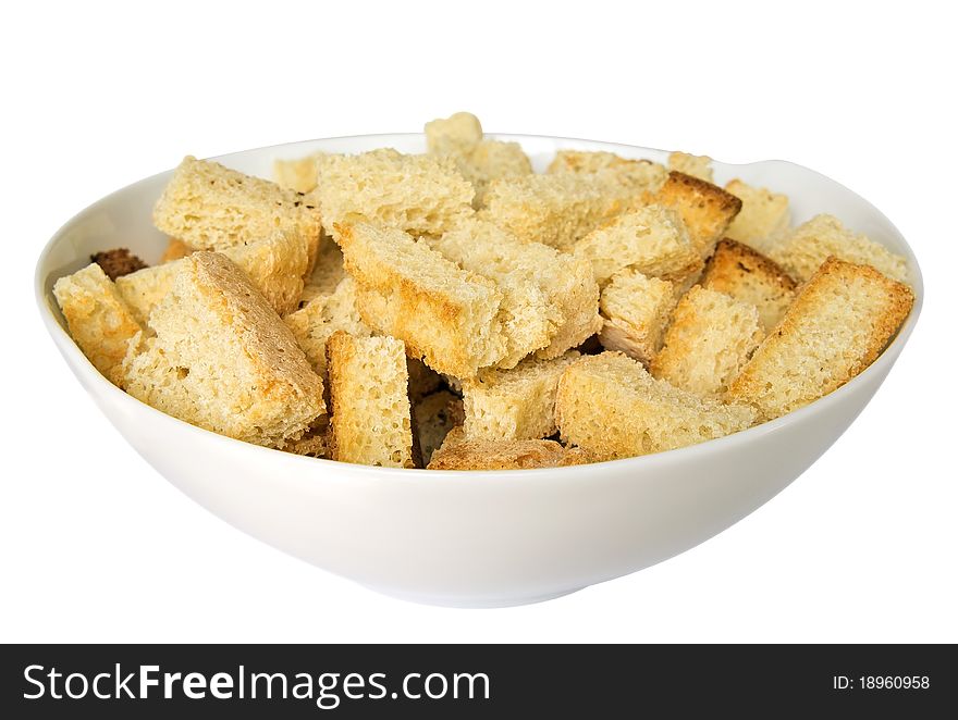 Crispy croutons in a white dish isolated on white. Clipping path included. Crispy croutons in a white dish isolated on white. Clipping path included.