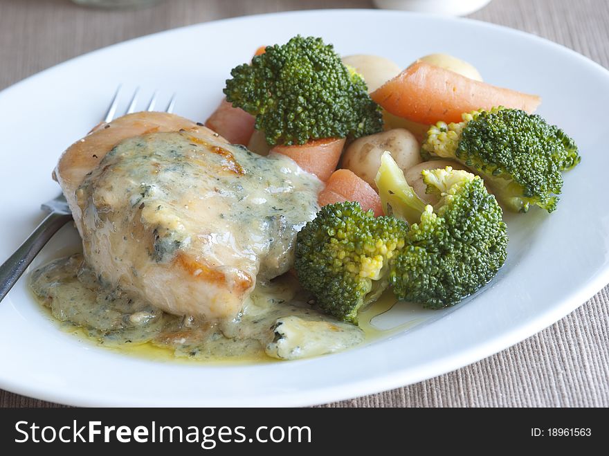 Pan-fried chicken breast with creamy basil sauce and vegetables. Pan-fried chicken breast with creamy basil sauce and vegetables